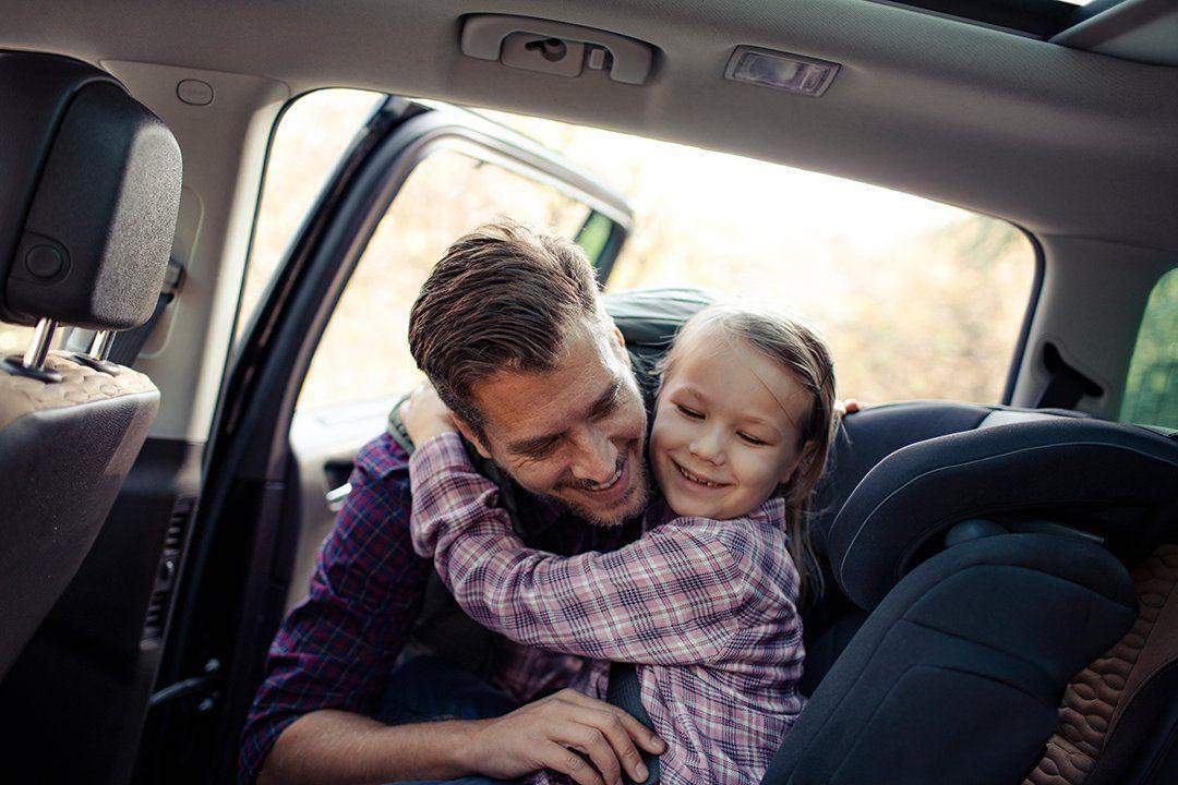 Father and daughter enjoying a clean car together